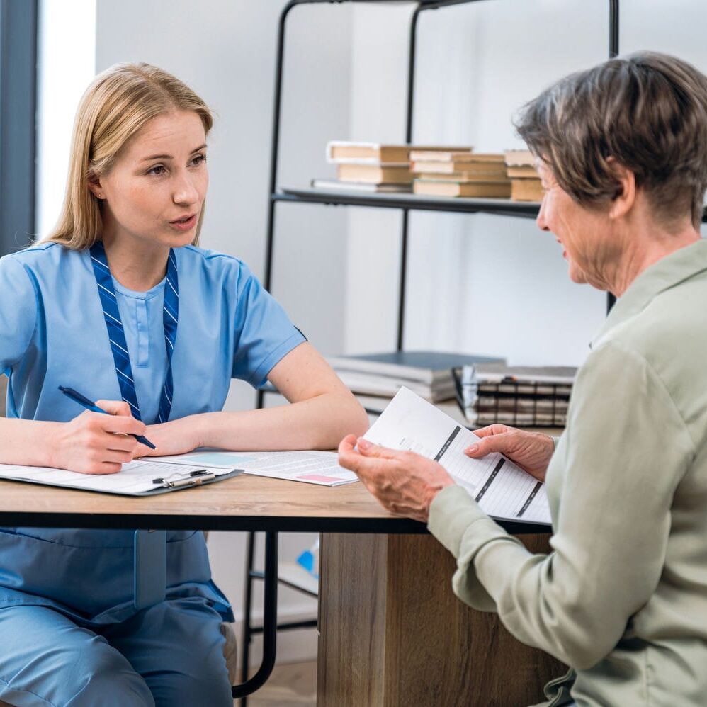 Clinician reviewing referral documentation with a patient during an assessment intake