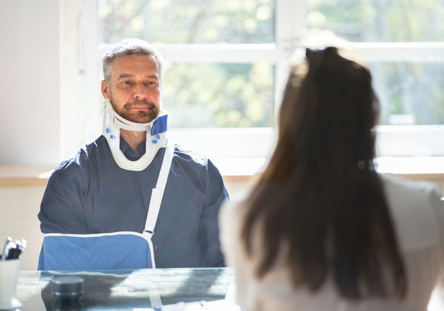 Patient wearing a neck brace during a coordinated medical assessment consultation