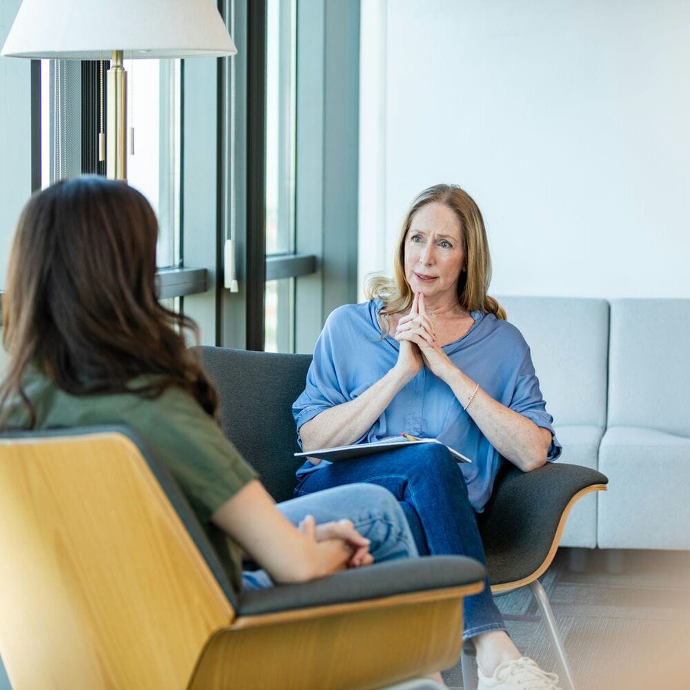 Clinician conducting a cognitive and psychological assessment consultation with an adult patient