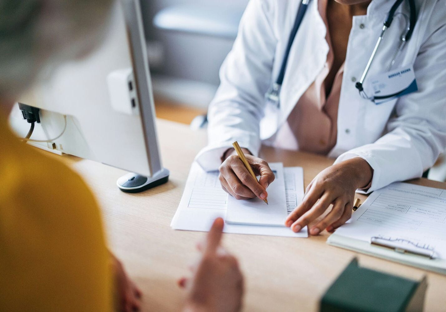 Clinician documenting findings during an objective medical assessment consultation