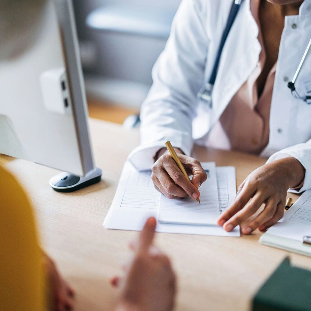 Clinician documenting findings during an objective medical assessment consultation