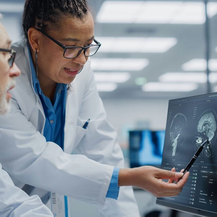Clinician reviewing diagnostic imaging results as part of a coordinated medical evaluation